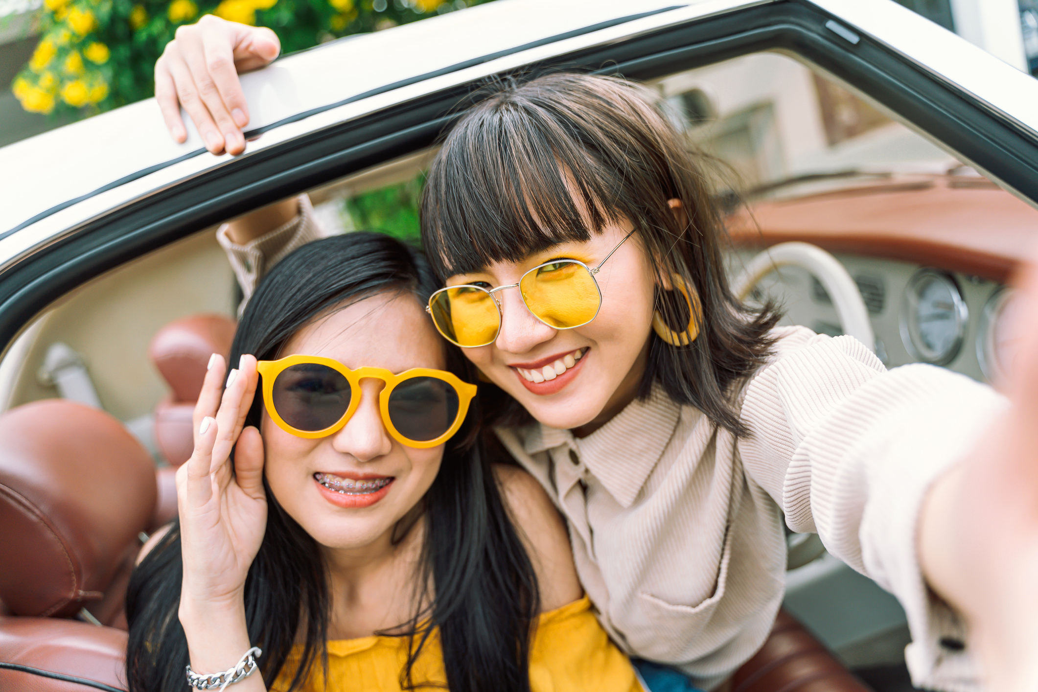 Portrait photo of young woman friends taking a self photo together with happy on road trip.